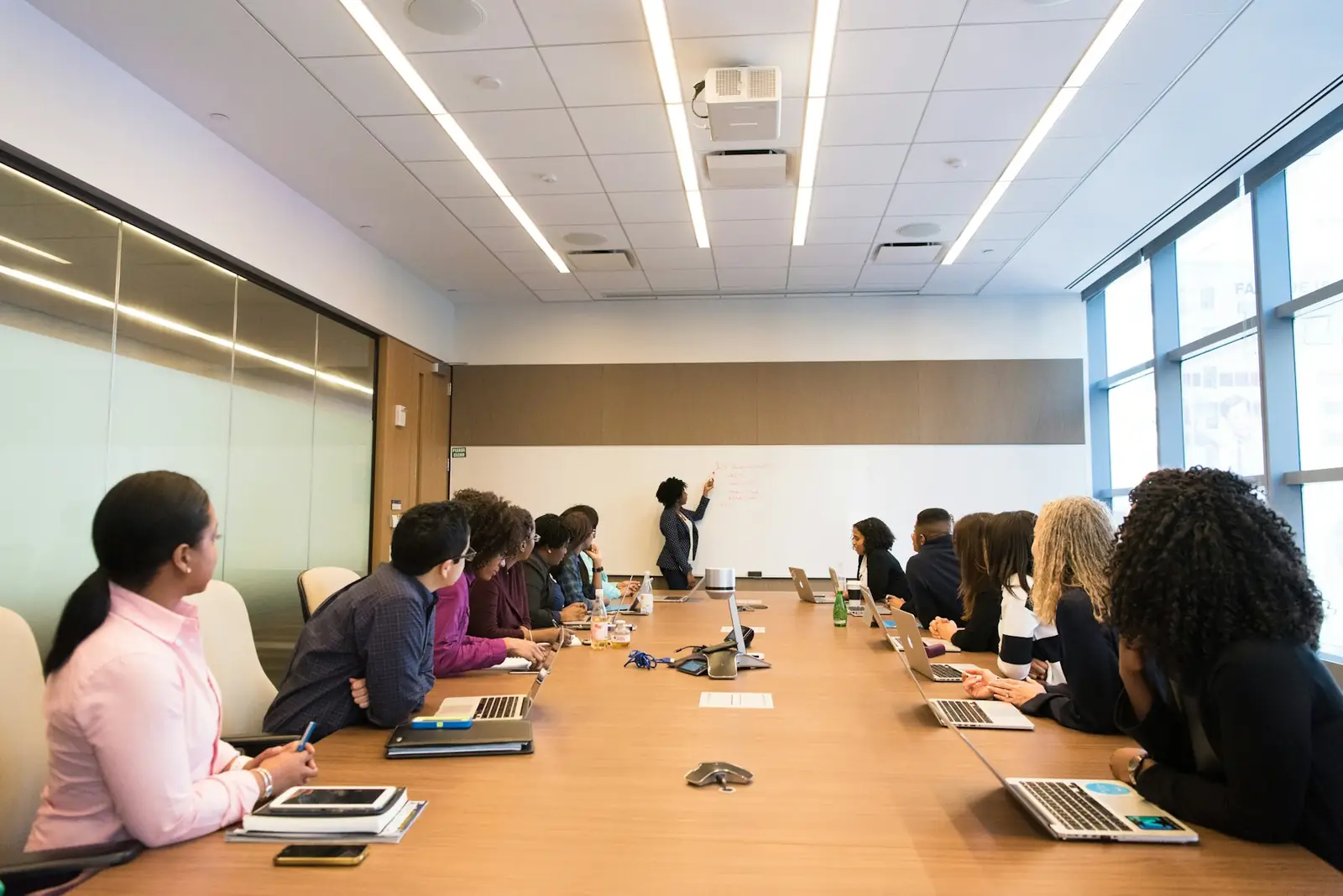 A team listening to a presentation in a meeting room