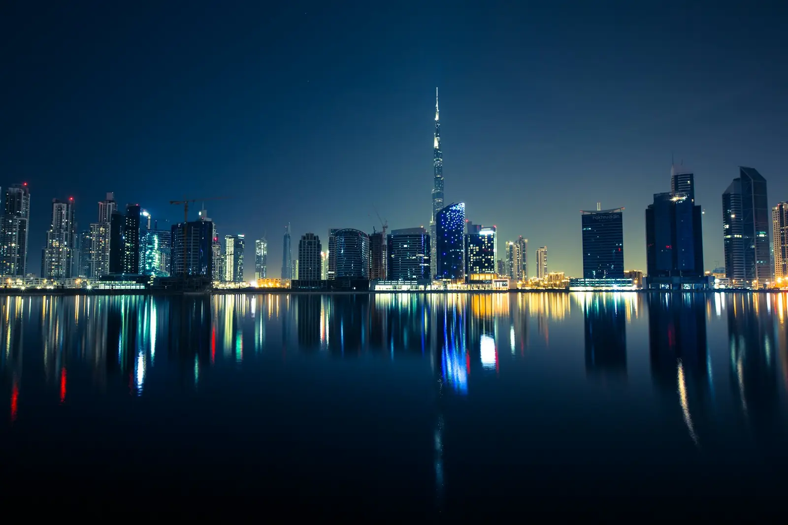 Dubai skyline reflected in the water at night