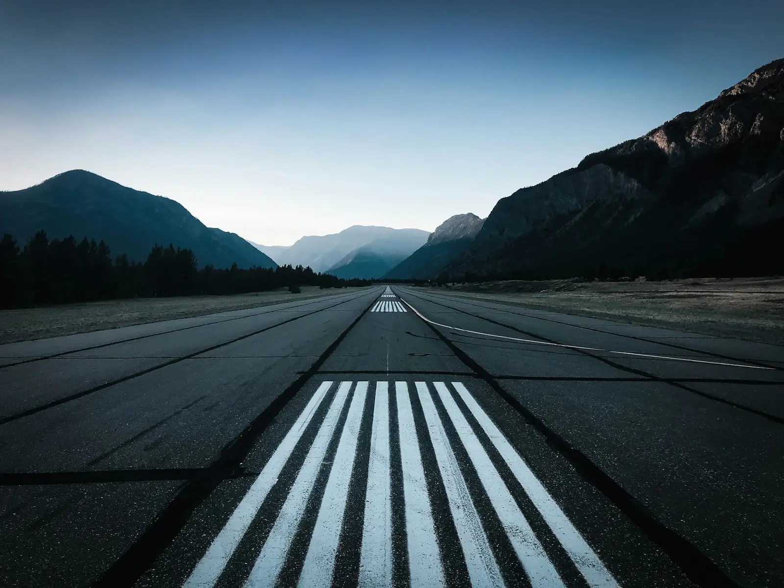 A runway stretching towards the mountains