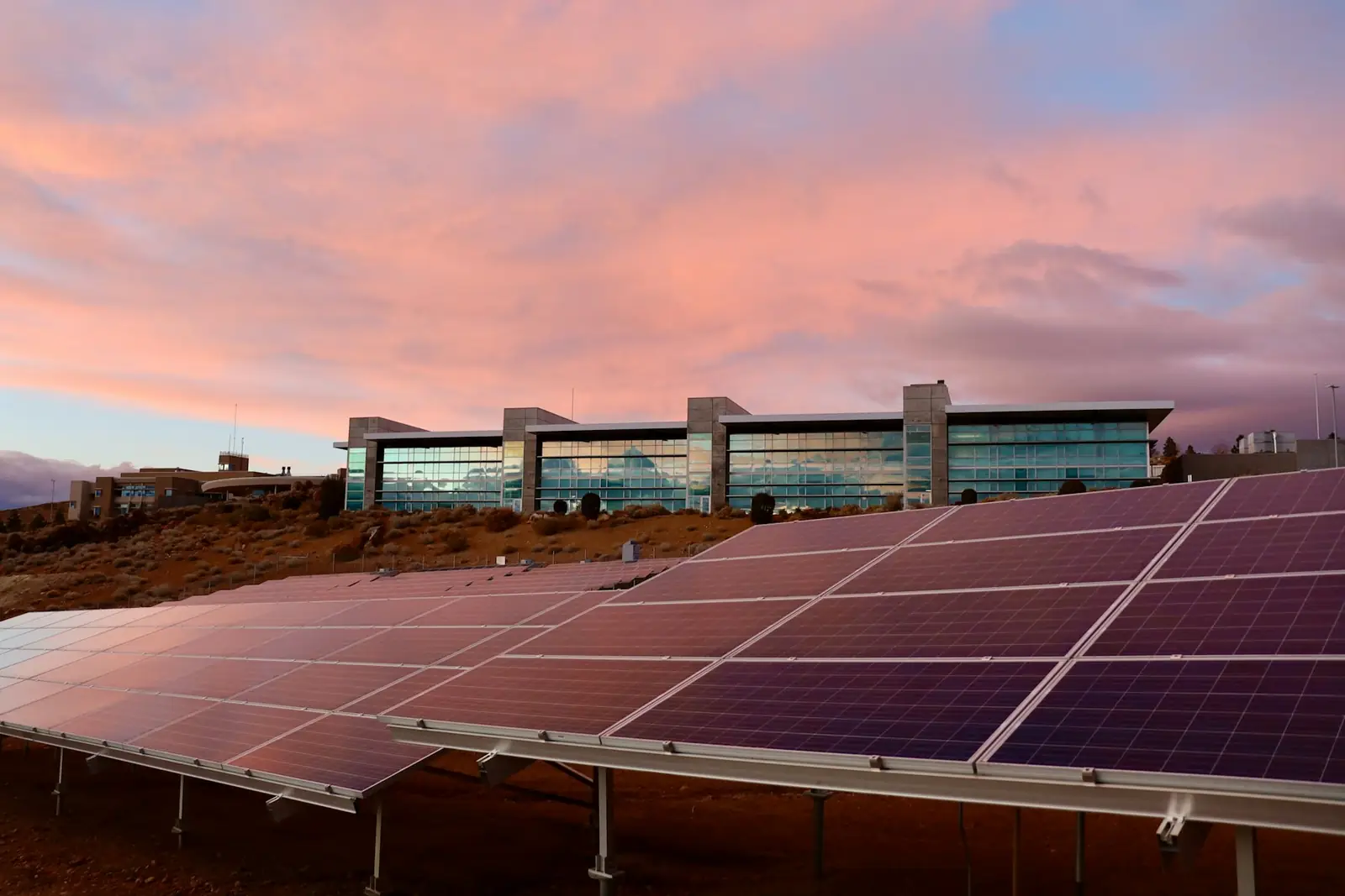 A solar power plant in the desert at sunset